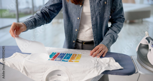 Woman Heat-Pressing Personalized Design Onto T-Shirt