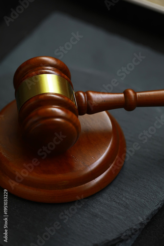 Wooden Gavel on Slate Surface Representing Justice and Legal Proceedings