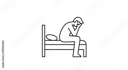 Man sitting on bed, head in hands, looking distressed and stressed