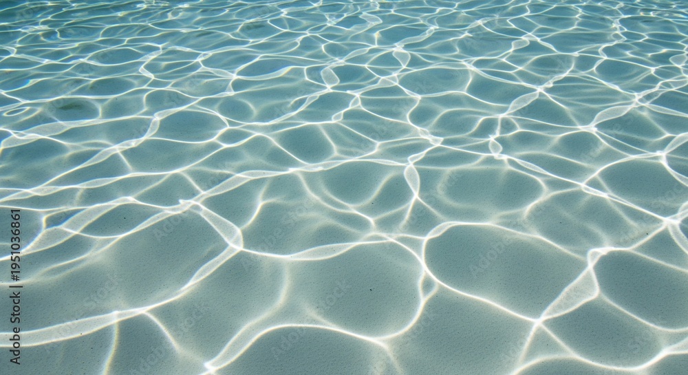 Fototapeta premium Abstract shimmering sunlight patterns on the sandy bottom of a clear blue swimming pool, creating a mesmerizing aquatic texture and tranquil relaxation vibe