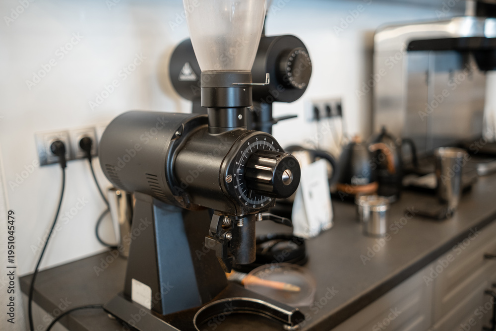 Fototapeta premium Coffee grinder on a kitchen countertop with modern appliances and tools in a contemporary kitchen setting