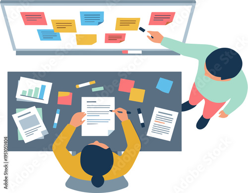 Two people working together on a project with papers and notes on a desk and board