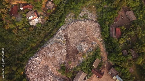 Ocean pollution in Sri Lanka jungle coastline, aerial drone view of trash dump in tropical nature near beach
