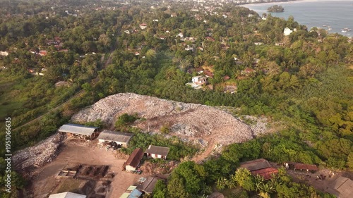 Plastic waste and trash polluting jungle coastline in Sri Lanka, drone shot of environmental damage near sea