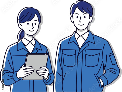 Two technicians in blue workwear standing together, male and female factory workers or engineers
