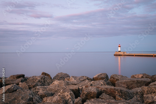 North Pier Lighthouse at dusk seen from the shoreline of Lake Superior in Duluth, Minnesota
