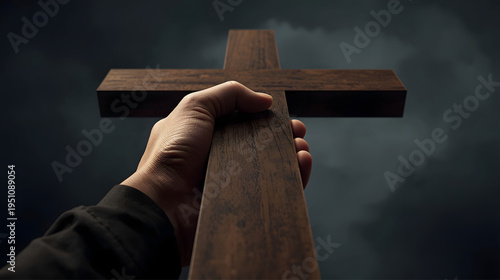 hand holding a big wooden cross with dynamic angle