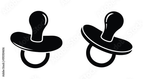 Two black pacifiers are displayed against a white background showcasing a simple silhouette
