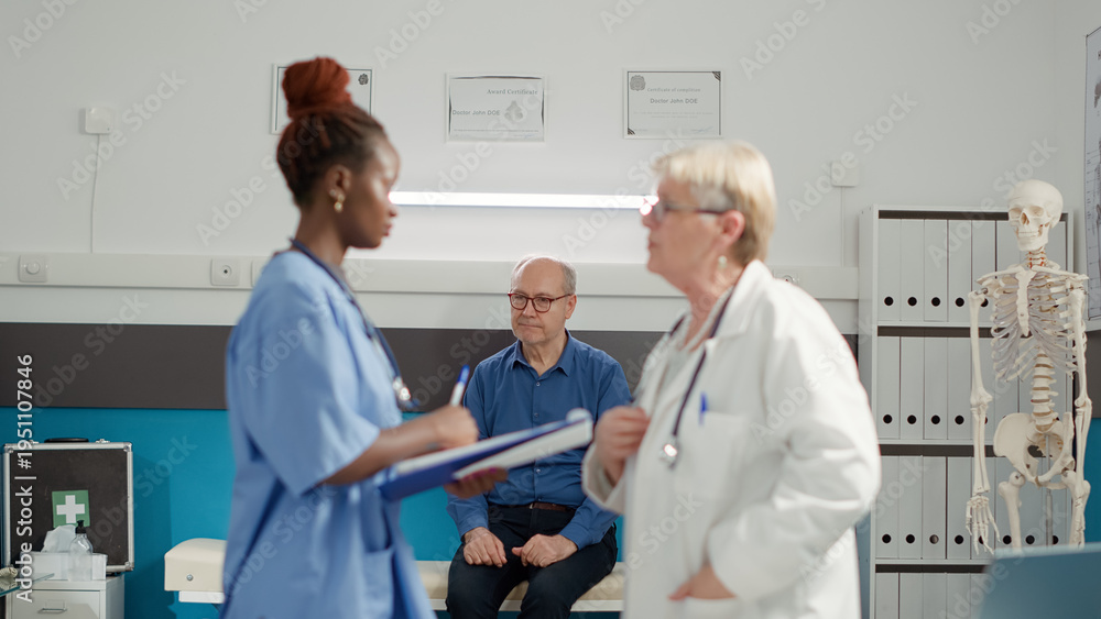 © DC Studio - Retired sick patient sitting in medical cabinet at checkup visit, using health care appointment to find diagnosis. Old person waiting to receive prescription medicine from medical team.