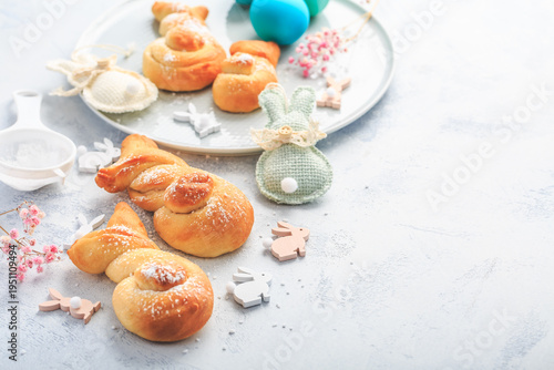 Traditional sweet Easter buns  with colorful eggs for a brunch