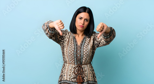 Woman giving two thumbs down with a displeased expression on her face