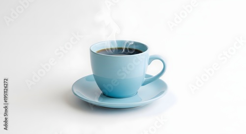 Light blue ceramic coffee cup with a matching saucer filled with steaming hot black coffee isolated on a plain white background surface