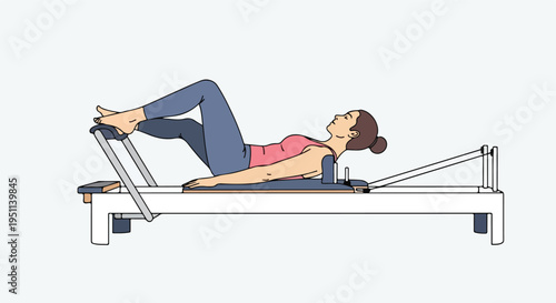 Woman exercising on a reformer machine, legs bent and propped up