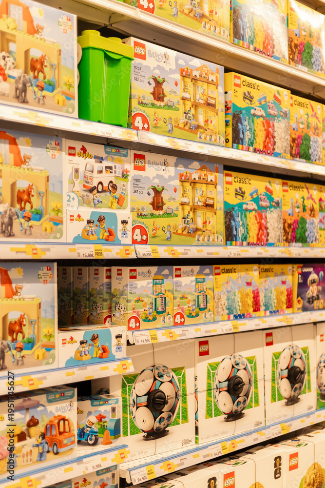 Fototapeta premium Chemnitz, Germany - March 14, 2026: Different LEGO building sets are arranged on shelves in a toy store. The wide variety of boxes includes themes for children of different ages