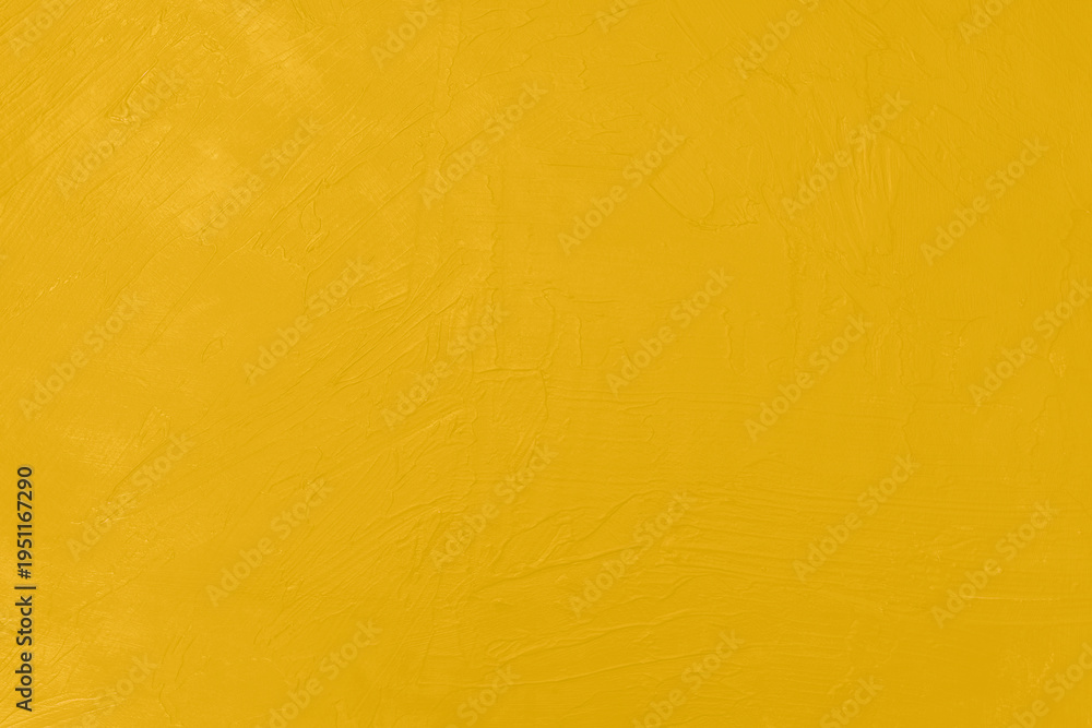 Naklejka premium Yellow painted wall with abstract textured surface and brush marks. Ideal background for design, branding, and vibrant concepts.