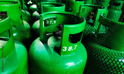 Fotografi Close-up of green LPG gas cylinders with valves in storage