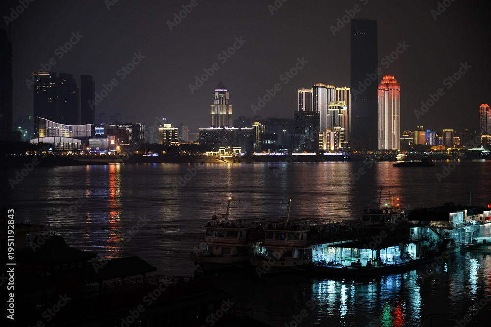 Obraz premium Night cityscape with high rise buildings and water reflection