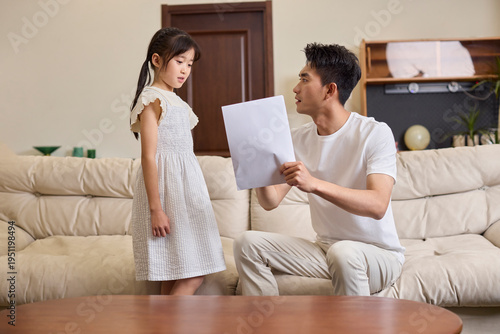 A dad helping his daughter with her studies