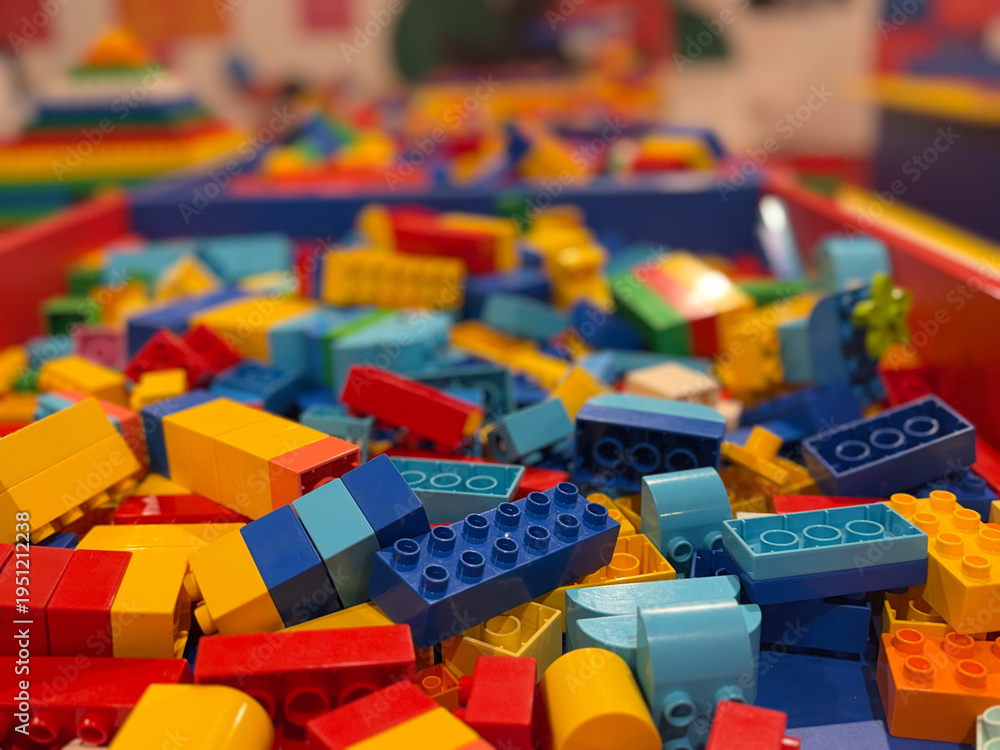 Fototapeta premium Colorful plastic building blocks in a bin