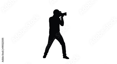 Photographer with camera poised capturing a moment in black silhouette