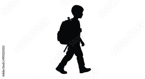 A young boy walking with a backpack striking black silhouette