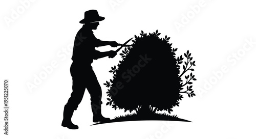Gardener trimming a large bush with shears stark black silhouette