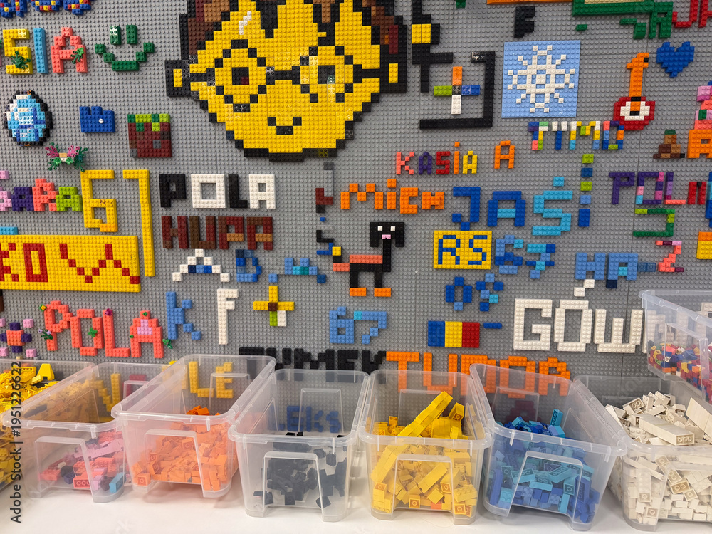 Naklejka premium Organized lego mosaic wall with sorted bins