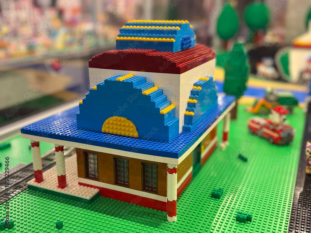 Naklejka premium Miniature lego building with blue curved roof