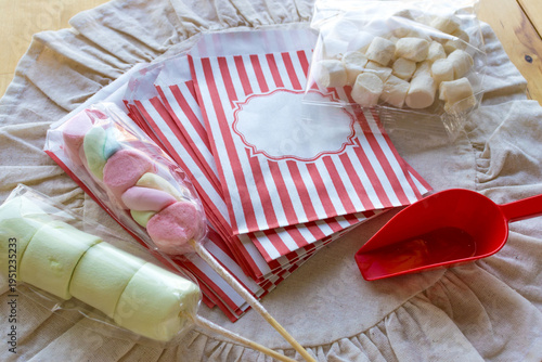 Quadro su tela Marshmallow skewers and candy packaging supplies on table