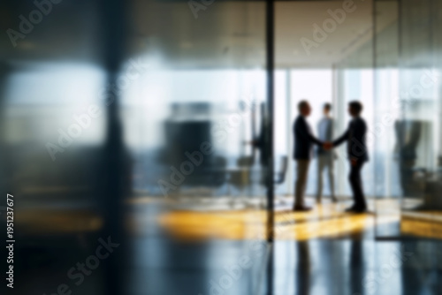 Blurred Businessmen shaking hands in modern office with glass walls