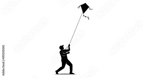 Man flying a black kite outdoors.