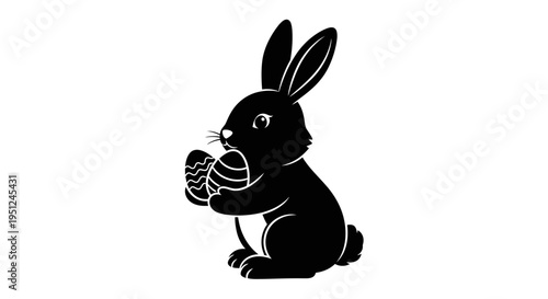 Black vector rabbit icon holding egg