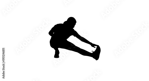 Silhouette of a person stretching their leg while seated on the ground.