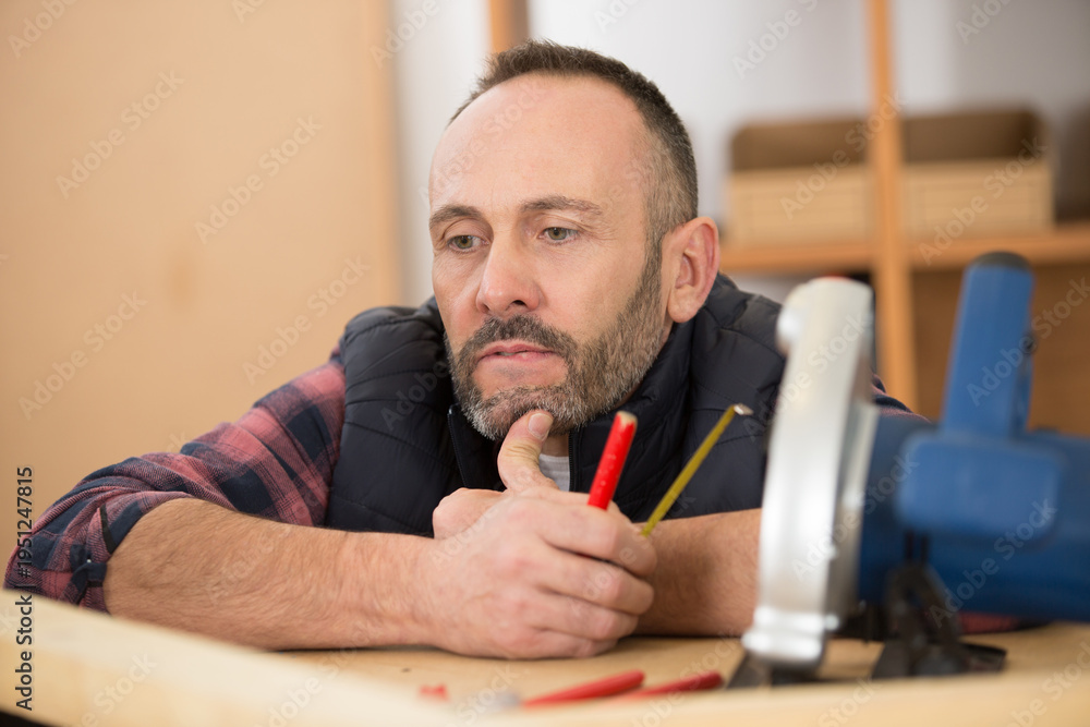 Fototapeta premium mature carpenter contemplating his crafts project