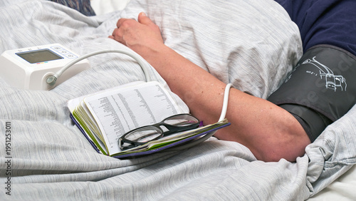A woman measures her blood pressure at home