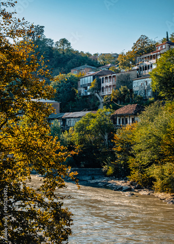 Traditional old georgian houses with their wooden carved balcony above the Rioni river in Kutaisi, Georgia