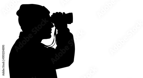 Man holding camera to face side.