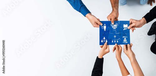 Tableau sur toile Dynamic image showcasing diverse hands coming together to hold a puzzle piece depicting symbols of business and technology, emphasizing collaboration and teamwork