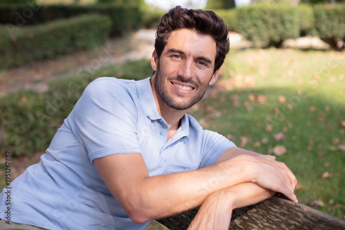 young handsome man posing in park