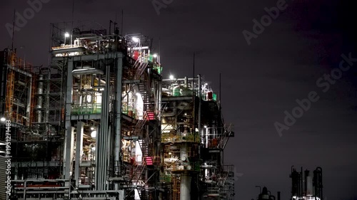 Night view of  industrial complex with glowing refineries