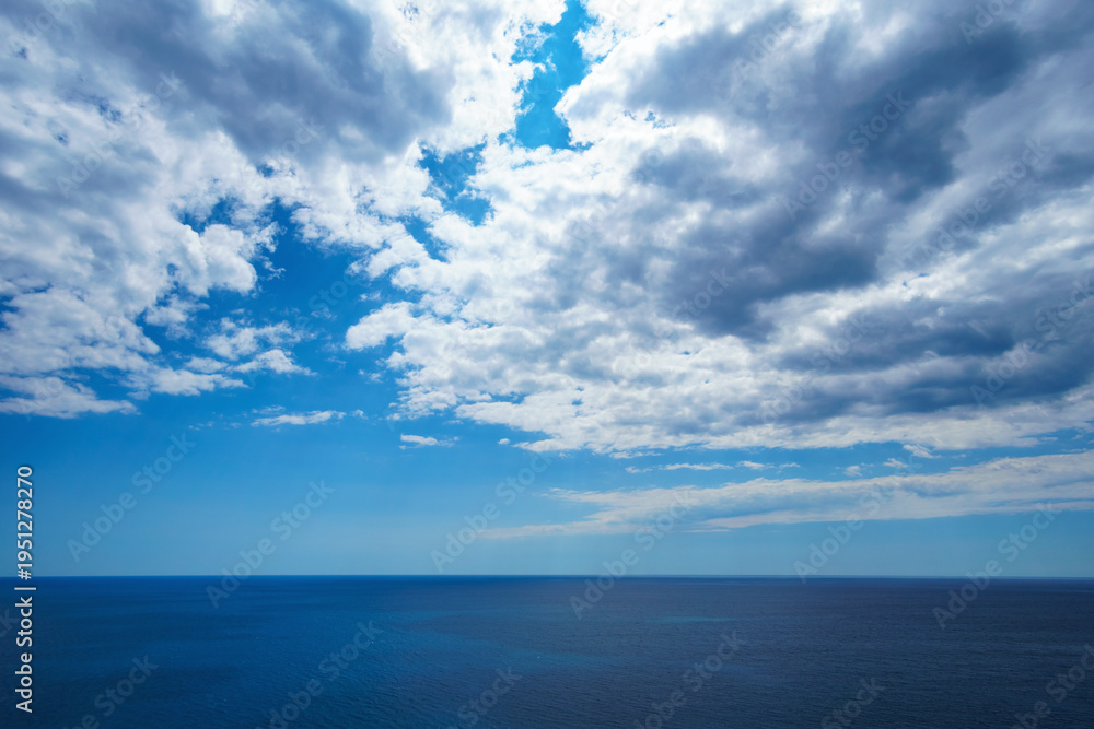 Obraz premium Minimalist summer background of blue Adriatic sea and dramatic cloudy sky in Montenegro. Mediterranean travel and freedom concept with copy space.