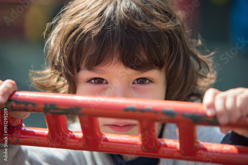 Wallpaper Mural close up of child holding playground ladder bar, focused expression, shallow depth of field, bright daylight, Torontodigital.ca