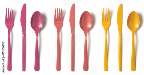 Colorful plastic utensils on white background pink yellow spoons