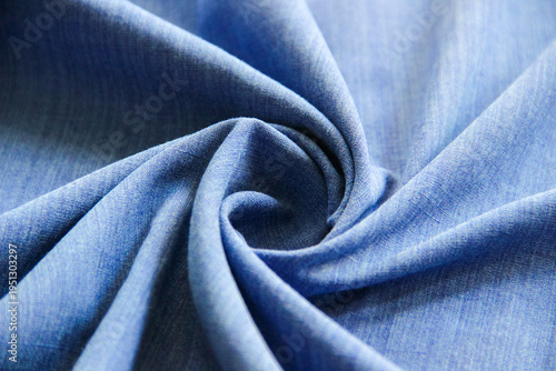 Tableau sur toile Blue fabric arranged in a spiral fold, showcasing smooth texture and elegant drapery