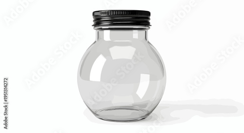 A clear glass jar with a black lid sits on a white surface indoors.