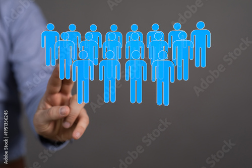 Hand pointing at a group of...