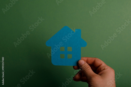 A hand holding a blue paper...