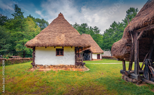 Impressive summer view of traditional romanian peasant houses. Spectacular rural scene of Transylvania, Romania, Europe. Beauty of countryside concept background.