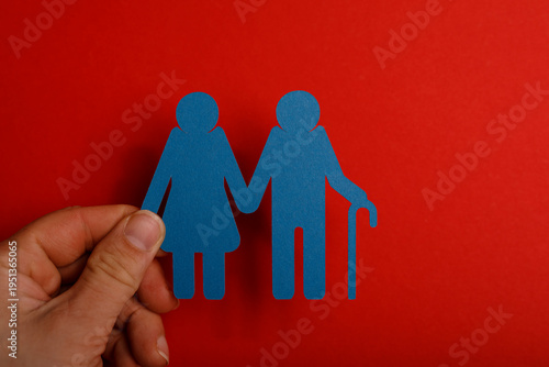 Hand holding paper cutouts ...