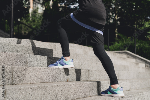 Картината върху платно Active woman stairs workout outdoors in the city park wearing sporty shoes and f